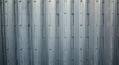 Close-up of a grey corrugated metal surface showcasing its uniform pattern and sturdy construction.