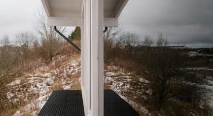 Snowy rural landscape with a modern shelter in winter.