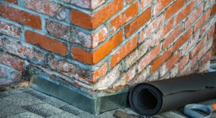 Detailed view of a brick chimney featuring construction tools and materials for repair.