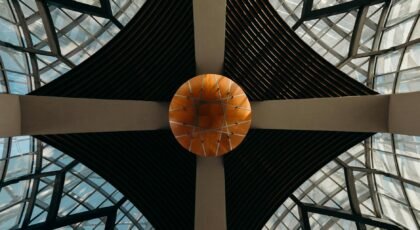 A dynamic view of a modern, geometric glass ceiling with futuristic elements.