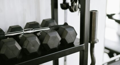 Close-up of gym equipment including dumbbells on a storage rack, perfect for fitness-themed uses.