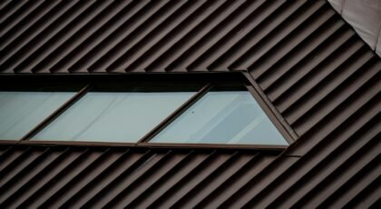 Close-up of a modern roof with geometric window design, highlighting metal texture.
