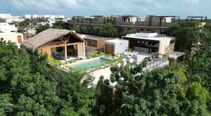 Aerial view of a luxury villa with a private pool nestled in the lush jungle of Tulum, Mexico.