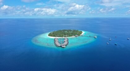 Stunning aerial view of island resort with turquoise waters, Maldives.