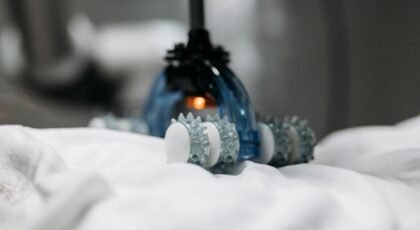 High-tech massage gadget resting on white fabric, showcasing innovation in relaxation technology.