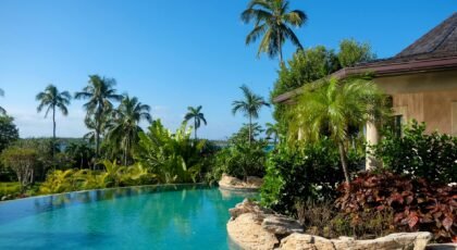A serene tropical poolside view with lush greenery in New York.