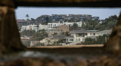 View of coastal homes framed by rustic stone, creating a unique perspective.