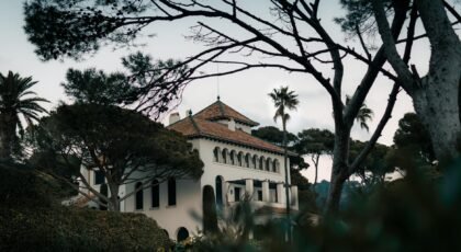 Elegant villa surrounded by Mediterranean greenery in Catalonia, Spain.
