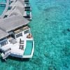 Breathtaking aerial view of a luxury overwater villa at Gaafu Dhaalu Atoll, Maldives.