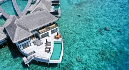 Breathtaking aerial view of a luxury overwater villa at Gaafu Dhaalu Atoll, Maldives.