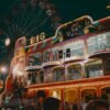 A lively scene at an amusement park with a ferris wheel and colorful lights at night.