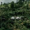Aerial shot of eco-friendly huts nestled in lush greenery in the Sri Lankan hills, perfect for eco-travelers.