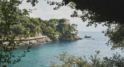Explore the stunning coastline of Portofino, Italy, featuring lush greenery and the vibrant blue sea.