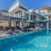 Stunning contemporary villa featuring a spacious infinity pool and breathtaking mountain backdrop.