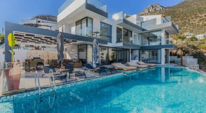 Stunning contemporary villa featuring a spacious infinity pool and breathtaking mountain backdrop.