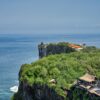 Majestic cliffside views overlooking the sea in Bali, highlighting lush greenery and architecture.