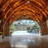 Stunning bamboo archway at a luxury resort in Vietnam with a view of the surrounding landscape.