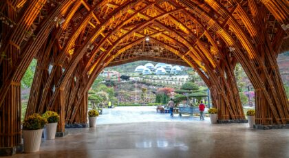 Stunning bamboo archway at a luxury resort in Vietnam with a view of the surrounding landscape.