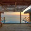 Stunning view of a luxury overwater villa in the Maldives at sunset, perfect for a tropical vacation.