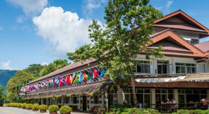 Doi Tung Palace adorned with international flags, nestled in Chiang Rai, Thailand.