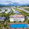 Stunning aerial shot of a resort with villas, pool, and lush greenery in Vietnam.