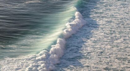 Stunning capture of powerful ocean waves crashing on the Bali coast, showcasing nature's beauty.