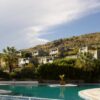Overlooking a serene pool and lush landscape in Bodrum, Türkiye, perfect summer getaway.