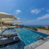 Elegant outdoor pool at a luxury villa with ocean view.