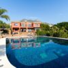 Stunning luxury villa with a swimming pool and mountain view, perfect for travel and lifestyle imagery.