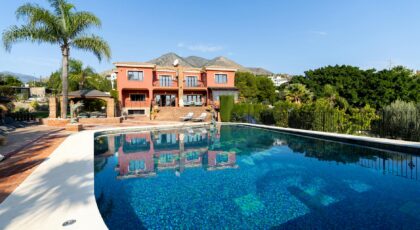 Stunning luxury villa with a swimming pool and mountain view, perfect for travel and lifestyle imagery.