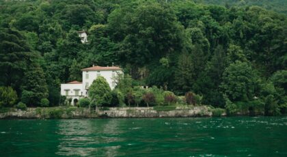 Charming villa by Lake Como surrounded by lush greenery in Lombardy, Italy.