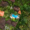 Stunning aerial shot of tropical villa with pool surrounded by lush greenery in Bali.