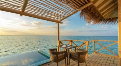Enjoy a peaceful sunrise view from an oceanfront villa in the Maldives, offering tranquility and beauty.