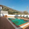 Relax at a luxurious villa with mountain-view pool and sun loungers.